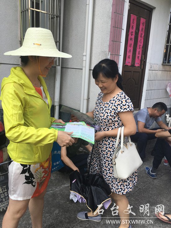图为志愿者对社区清理整治